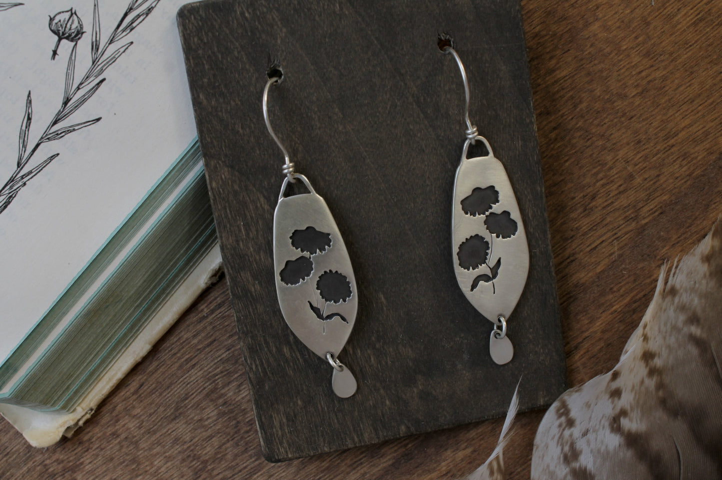 Coneflower dangle earrings, handmade floral earrings, recycled sterling silver earrings, nature-inspired jewelry, sustainable jewelry, eco-friendly earrings, botanical jewelry, artisan-made earrings, flower earrings, unique dangle earrings, handmade earrings, ethical jewelry, boho floral earrings, sustainable fashion, handmade in USA, eco-conscious jewelry, handcrafted earrings, statement floral earrings, heirloom quality earrings, wildflower earrings