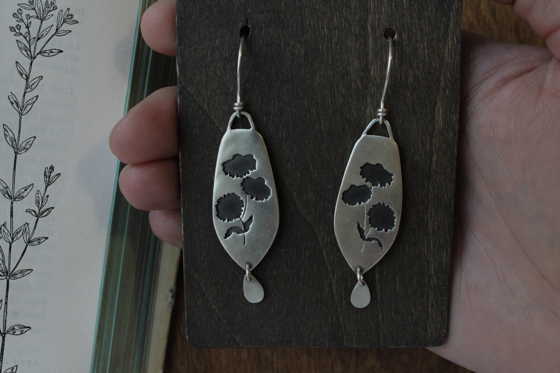Coneflower dangle earrings, handmade floral earrings, recycled sterling silver earrings, nature-inspired jewelry, sustainable jewelry, eco-friendly earrings, botanical jewelry, artisan-made earrings, flower earrings, unique dangle earrings, handmade earrings, ethical jewelry, boho floral earrings, sustainable fashion, handmade in USA, eco-conscious jewelry, handcrafted earrings, statement floral earrings, heirloom quality earrings, wildflower earrings