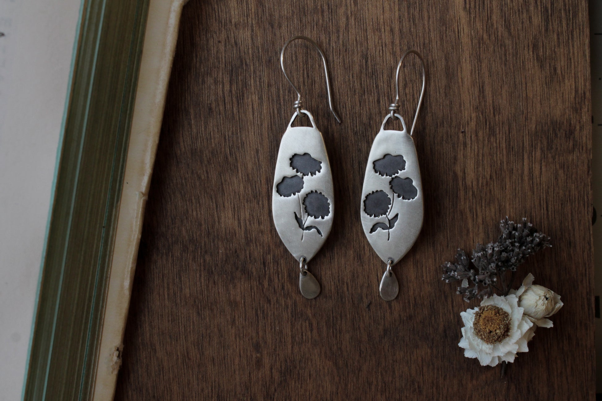 Coneflower dangle earrings, handmade floral earrings, recycled sterling silver earrings, nature-inspired jewelry, sustainable jewelry, eco-friendly earrings, botanical jewelry, artisan-made earrings, flower earrings, unique dangle earrings, handmade earrings, ethical jewelry, boho floral earrings, sustainable fashion, handmade in USA, eco-conscious jewelry, handcrafted earrings, statement floral earrings, heirloom quality earrings, wildflower earrings