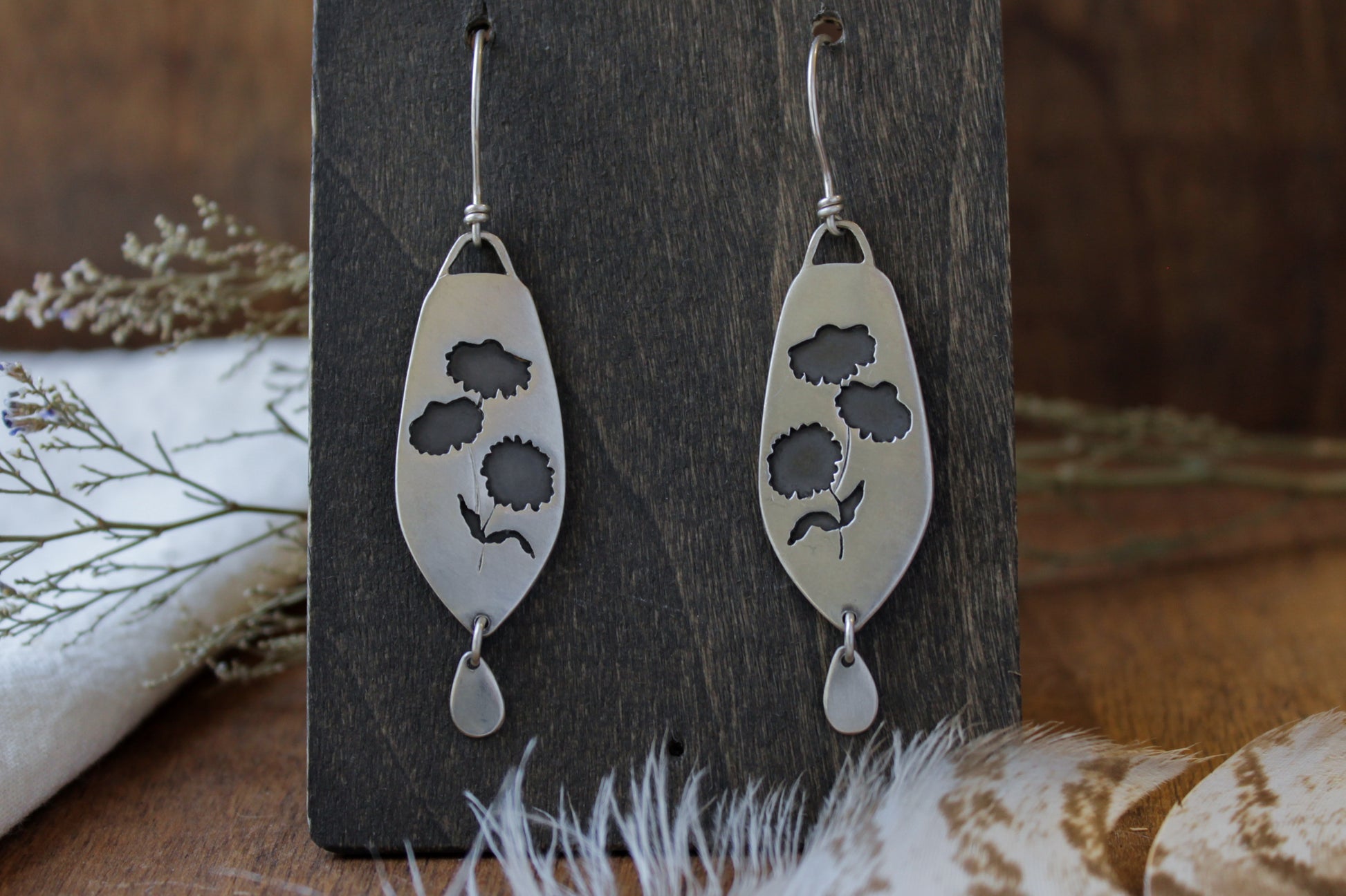 Coneflower dangle earrings, handmade floral earrings, recycled sterling silver earrings, nature-inspired jewelry, sustainable jewelry, eco-friendly earrings, botanical jewelry, artisan-made earrings, flower earrings, unique dangle earrings, handmade earrings, ethical jewelry, boho floral earrings, sustainable fashion, handmade in USA, eco-conscious jewelry, handcrafted earrings, statement floral earrings, heirloom quality earrings, wildflower earrings