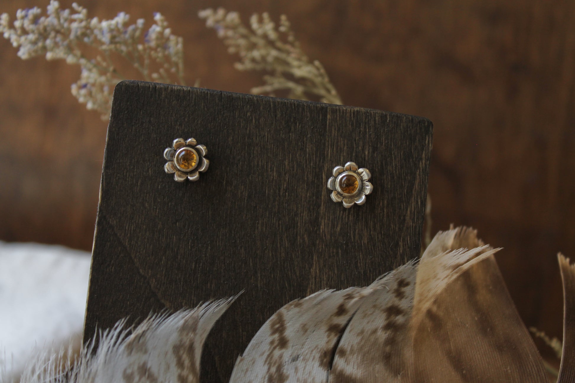 handmade daisy stud earrings, citrine earrings, sustainable floral jewelry, eco-friendly earrings, recycled sterling silver earrings, nature-inspired jewelry, floral earrings, sustainable jewelry, unique jewelry design, handcrafted earrings, daisy earrings, boho chic jewelry, mindful craftsmanship, artisanal earrings, sterling silver earrings, slow fashion, heirloom jewelry, ethically made jewelry, small batch jewelry, sustainable fashion accessories