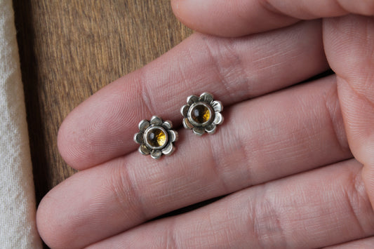 handmade daisy stud earrings, citrine earrings, sustainable floral jewelry, eco-friendly earrings, recycled sterling silver earrings, nature-inspired jewelry, floral earrings, sustainable jewelry, unique jewelry design, handcrafted earrings, daisy earrings, boho chic jewelry, mindful craftsmanship, artisanal earrings, sterling silver earrings, slow fashion, heirloom jewelry, ethically made jewelry, small batch jewelry, sustainable fashion accessories