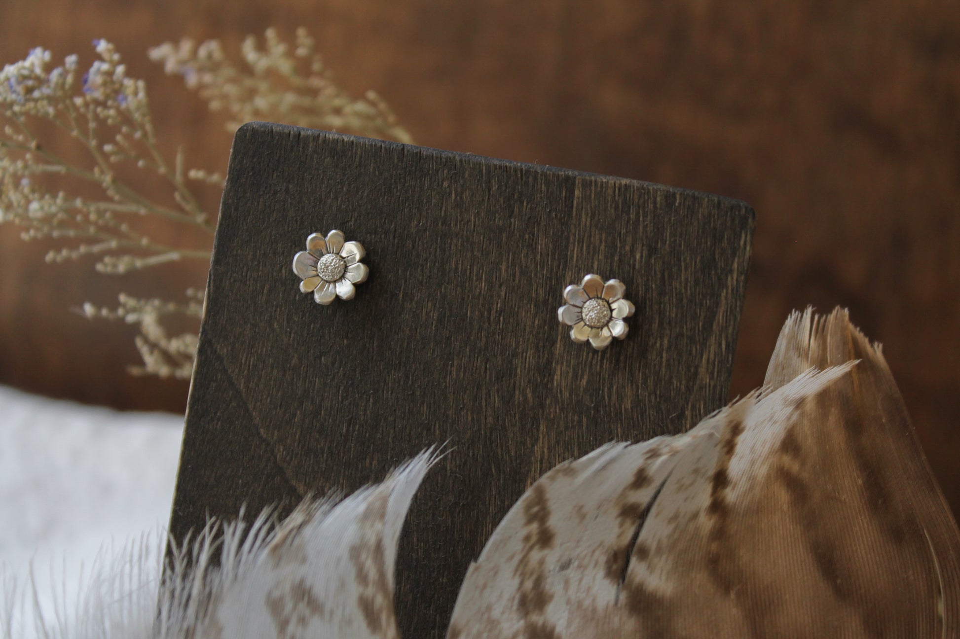 daisy stud earrings, handmade sterling silver jewelry, floral stud earrings, nature-inspired earrings, eco-friendly jewelry, sustainable jewelry, handcrafted earrings, sterling silver studs, daisy earrings, artisan jewelry, flower stud earrings, recycled silver earrings, minimalist floral earrings, eco-conscious jewelry, boho earrings, nature jewelry, ethical jewelry, small floral studs, delicate earrings, dainty stud earrings