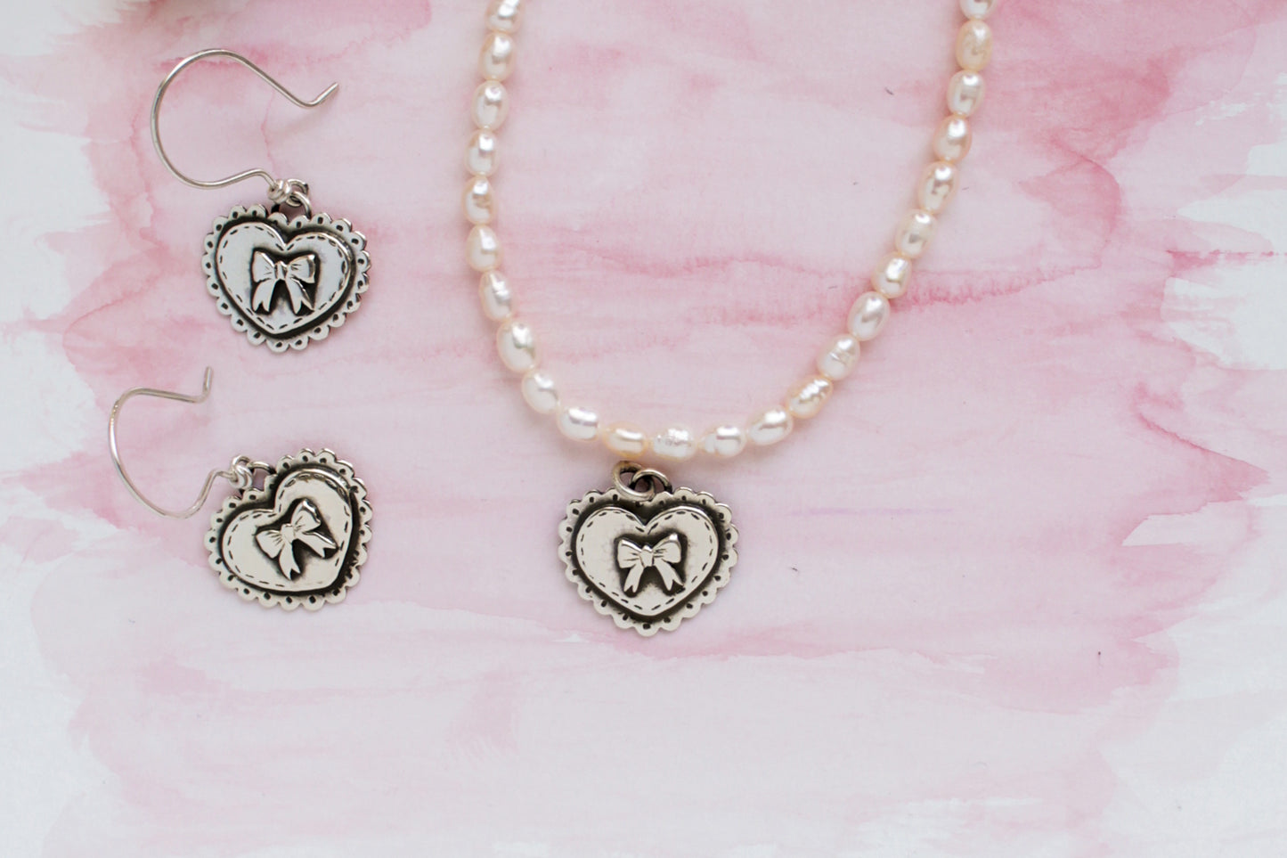 Handcrafted sterling silver heart pendant necklace and earring set with genuine pearls, inspired by Valentine’s Day romance and timeless love.