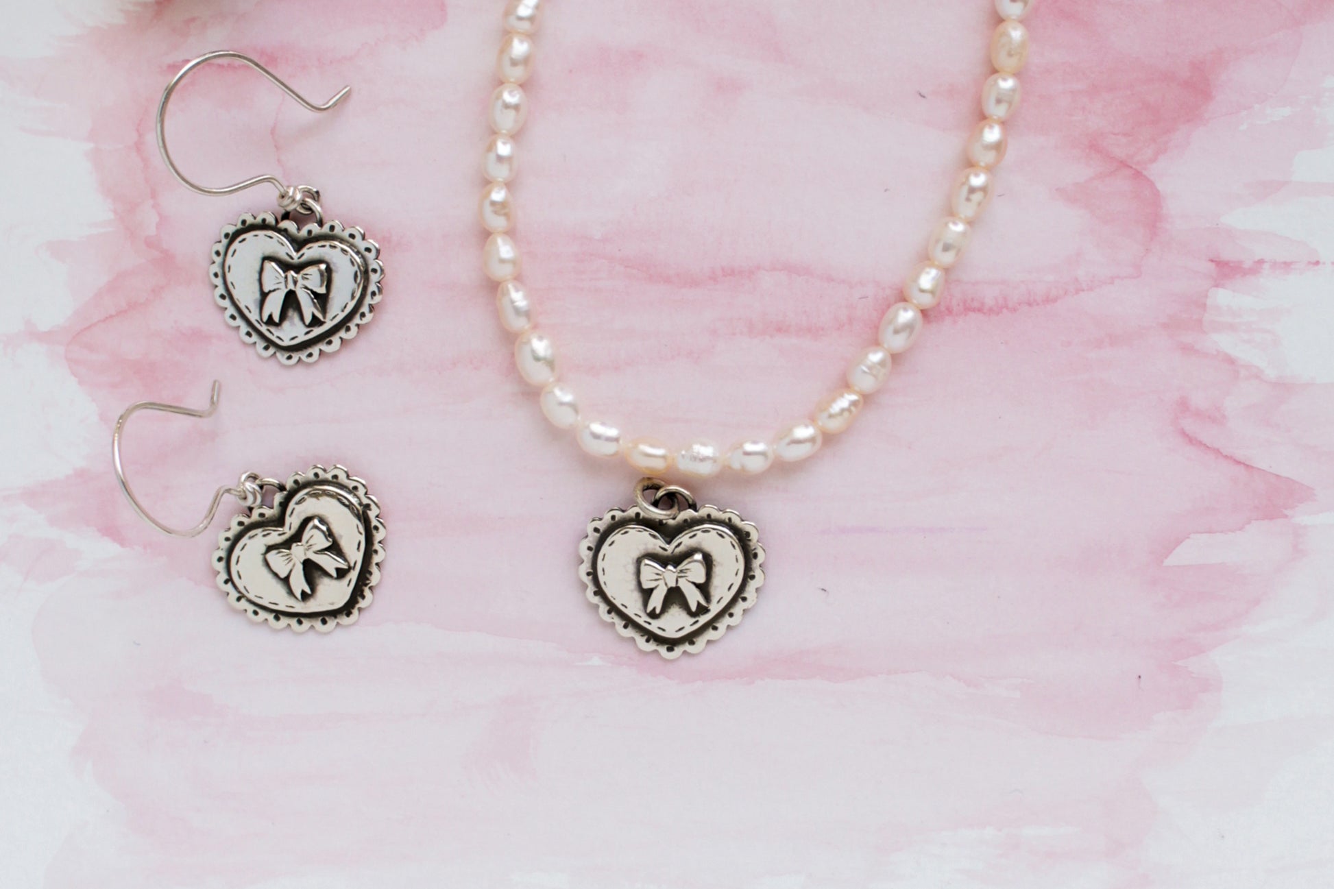Handcrafted sterling silver heart pendant necklace and earring set with genuine pearls, inspired by Valentine’s Day romance and timeless love.