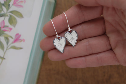 Medium-sized sterling silver dangle earrings with hand-stamped heart designs inspired by first love and playful doodles, perfect for Valentine’s Day gifts.