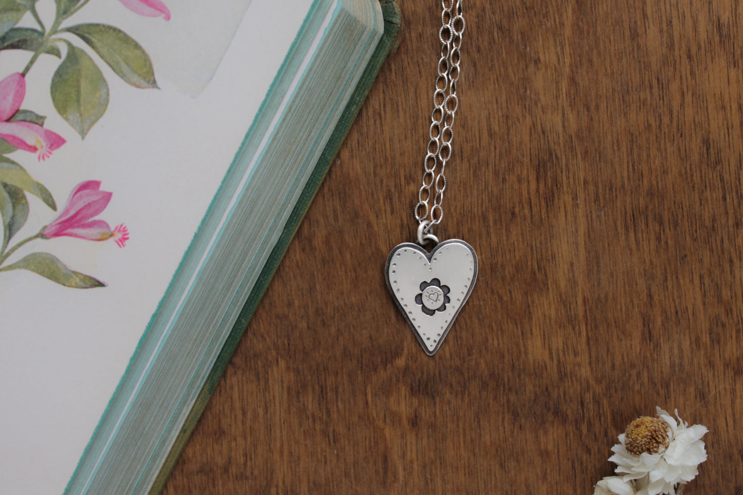 Sustainable sterling silver heart pendant necklace with a playful hand-stamped design, ideal for eco-conscious jewelry lovers.