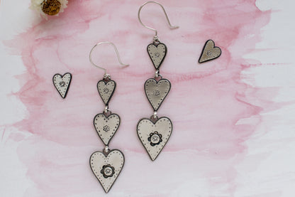 Handcrafted sterling silver heart earrings with doodle-inspired details, a nostalgic nod to first love, designed for eco-conscious jewelry lovers.