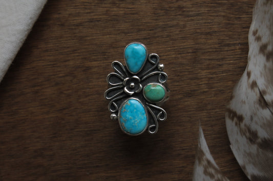 Vintage-inspired turquoise cluster ring featuring genuine blue and green turquoise stones with handcrafted silver floral and swirl details