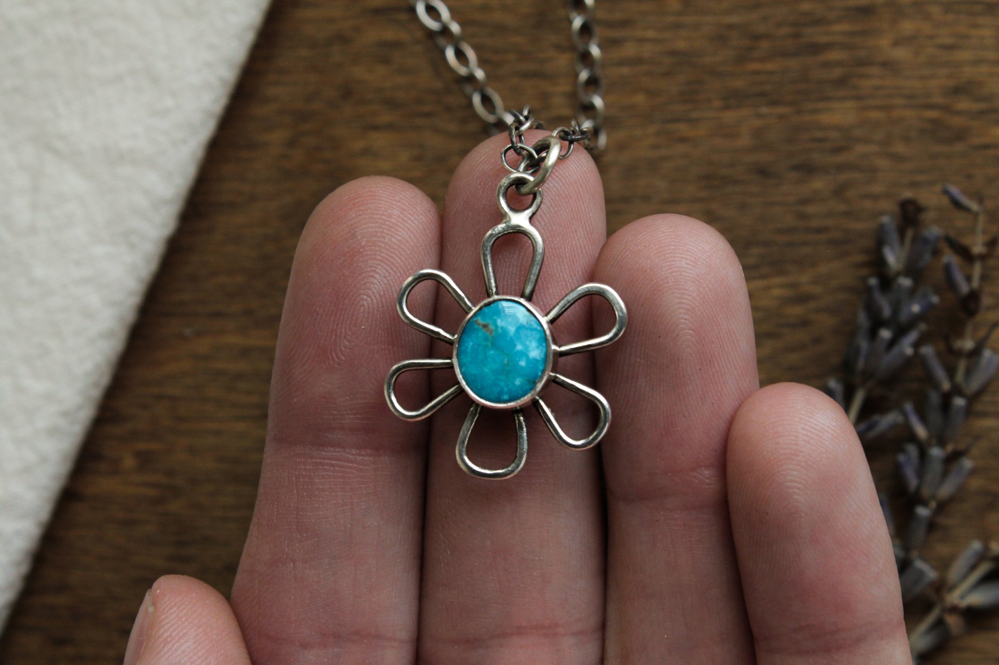 Close-up of Flower Power Necklace, showcasing turquoise stone in a unique daisy-inspired pendant crafted from recycled sterling silver.