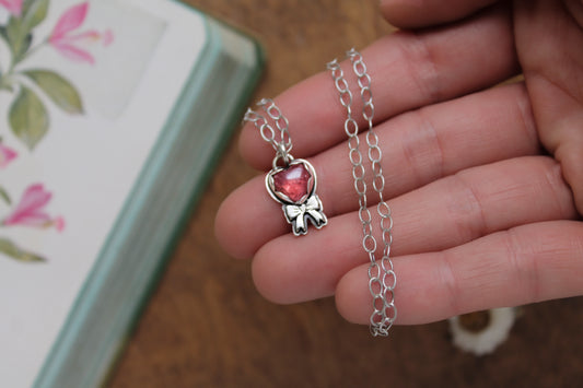 Valentine's-inspired rose quartz pendant necklace with oxidized sterling silver chain and a sweet handcrafted bow detail.