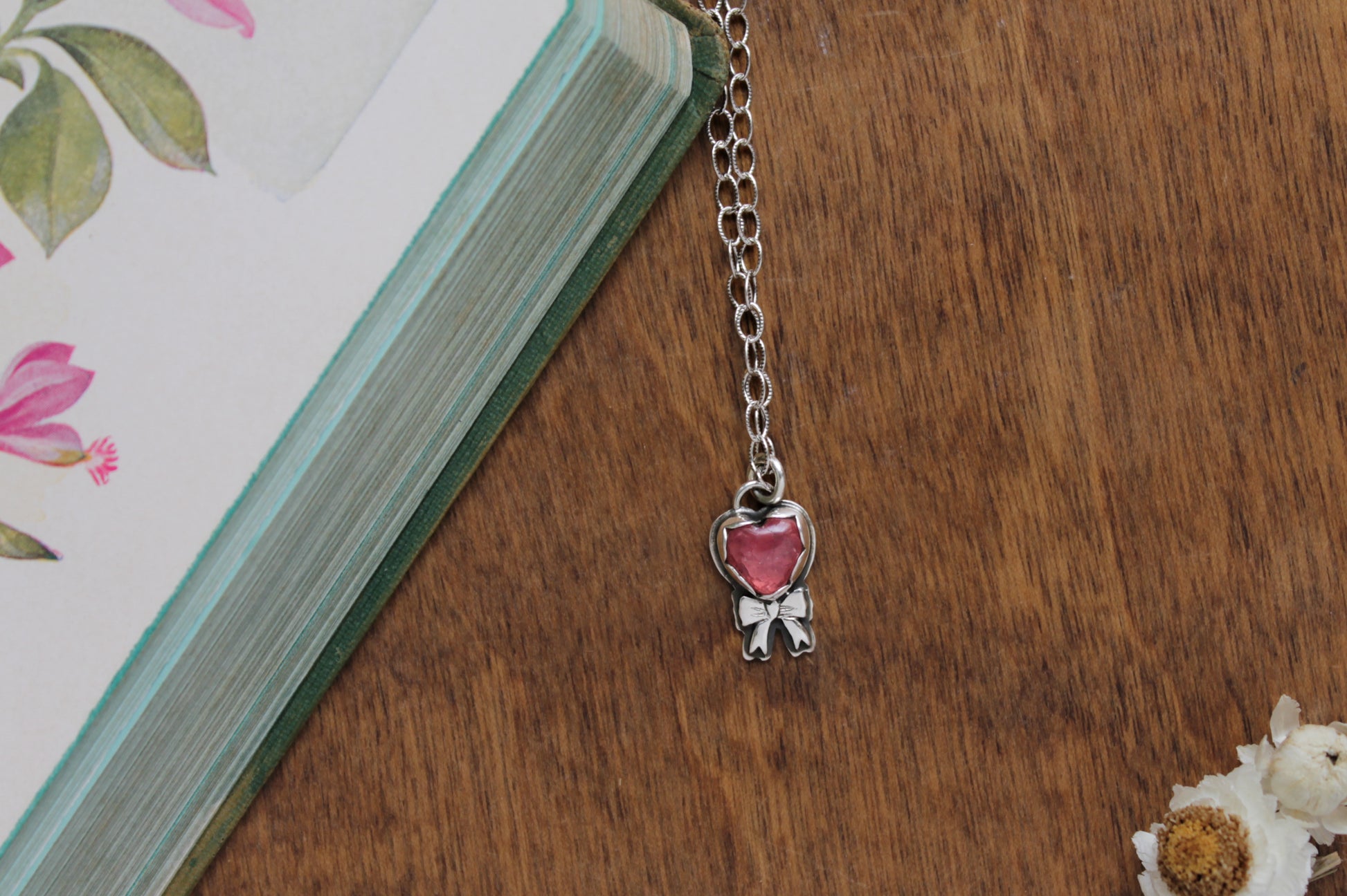 Handmade Hearts Promise Rose Quartz Necklace with a genuine rose quartz gemstone in a sterling silver bezel setting and sweet bow detail.