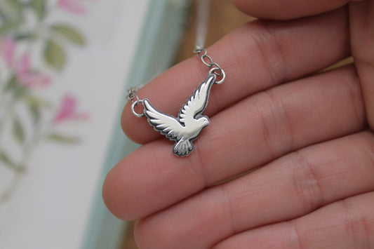 Romantic sterling silver love bird pendant necklace with a polished satin finish, ideal for layering or gifting.