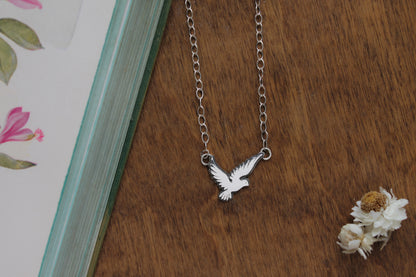 Eco-conscious Love Bird Necklace featuring a whimsical bird design on an oxidized adjustable sterling silver chain.