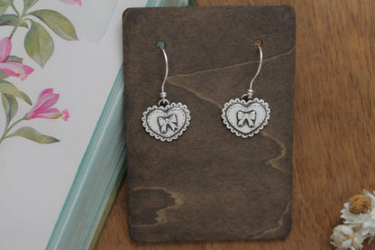 Eco-friendly sterling silver heart earrings with vintage-inspired designs, ideal for romantic or special occasions.