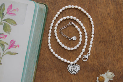 Love Bound Necklace featuring a satin-finished silver heart and classic pearls, blending timeless beauty with sustainable design.