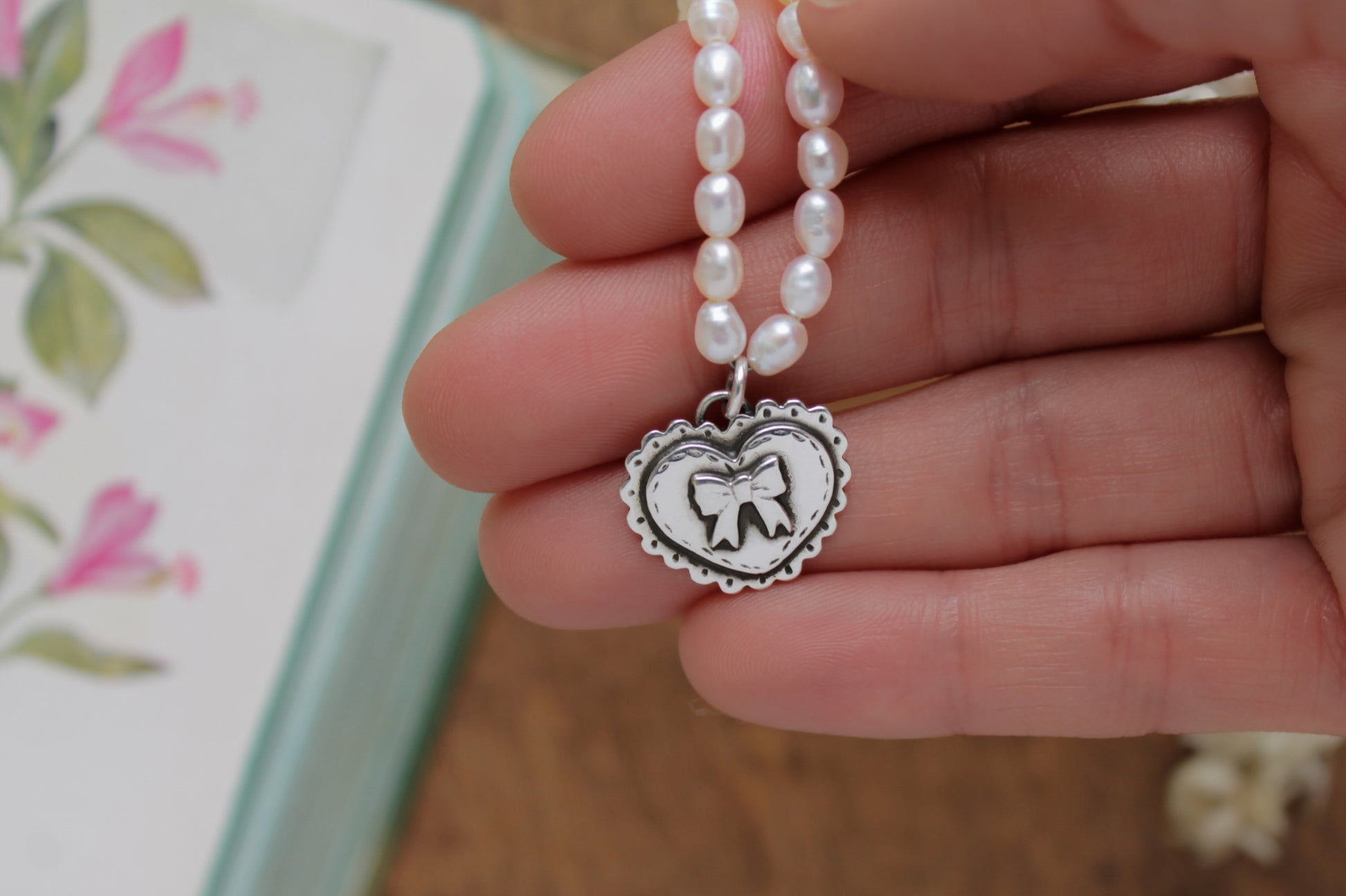 Valentine-inspired heart pendant necklace with ethically sourced pearls and sterling silver details.