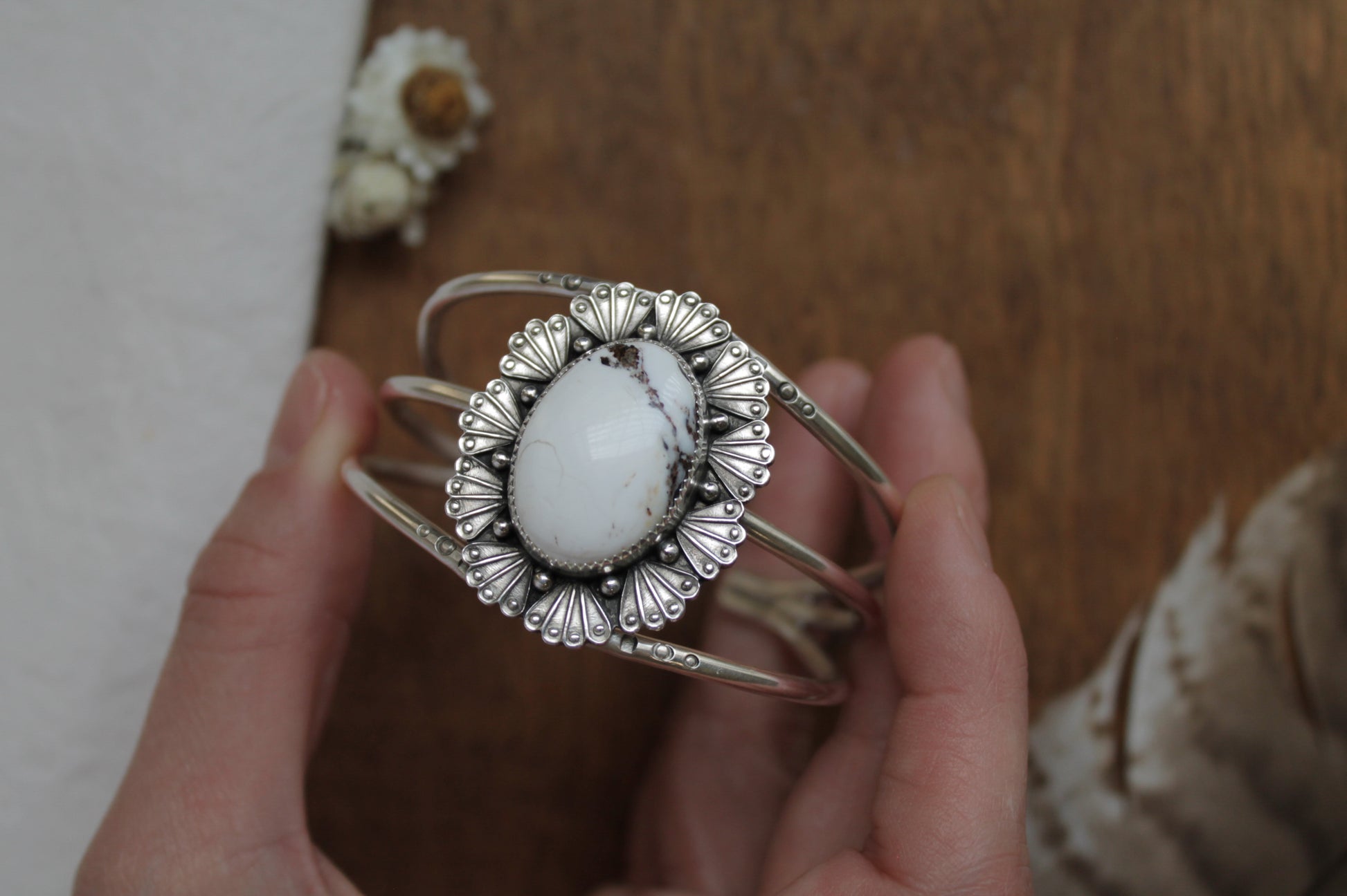 Western Art Deco statement cuff with White Buffalo stone and hand stamped sterling silver details. Sustainable handmade jewelry featuring intricate fan pattern, beaded accents, and adjustable band. Bohemian silver bracelet perfect for everyday statement style.