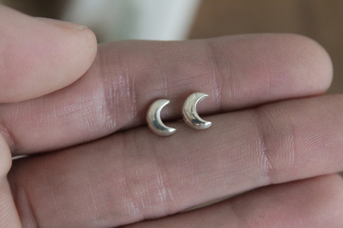 Celestial sterling silver stud earrings, handmade jewelry, celestial earrings, moon and star earrings, artisan earrings, sterling silver earrings, eco-friendly jewelry, nature-inspired jewelry, minimalistic jewelry, sustainable jewelry, celestial stud earrings, everyday earrings, handmade earrings, ethical jewelry, recycled silver earrings, celestial jewelry, silver studs, celestial-themed jewelry, artisan silver earrings, star and moon jewelry