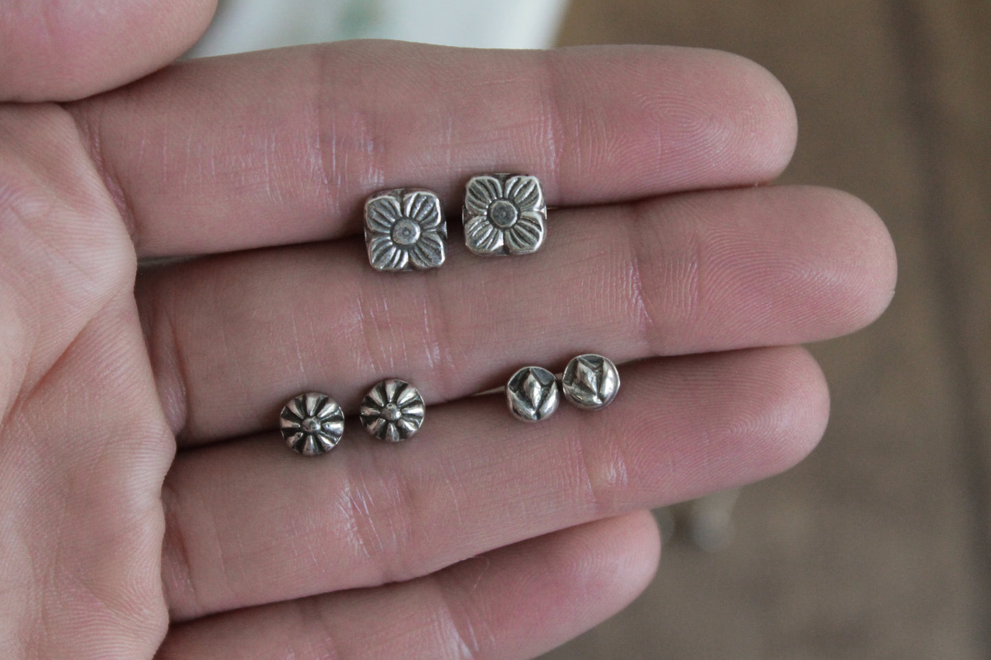 floral sterling silver stud earrings, sterling silver stud earrings, floral earrings, sustainable jewelry, handmade earrings, eco-friendly earrings, nature-inspired earrings, recycled silver jewelry, floral silver studs, artisan jewelry, ethical jewelry, minimalist earrings, everyday earrings, unique jewelry design, heirloom-quality earrings, handcrafted earrings, eco-conscious jewelry, floral stud earrings for women, silver flower earrings, dainty silver earrings